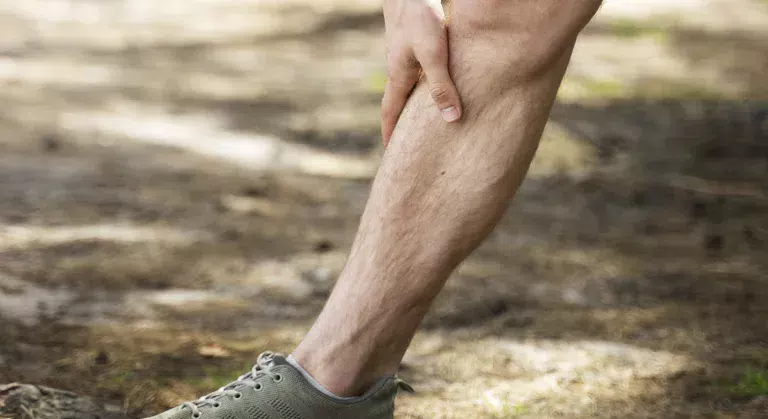 side view man stretching leg outdoors